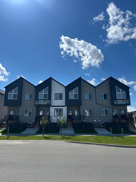 Apartment complex with the words "FOR RENT" on the front of each building.