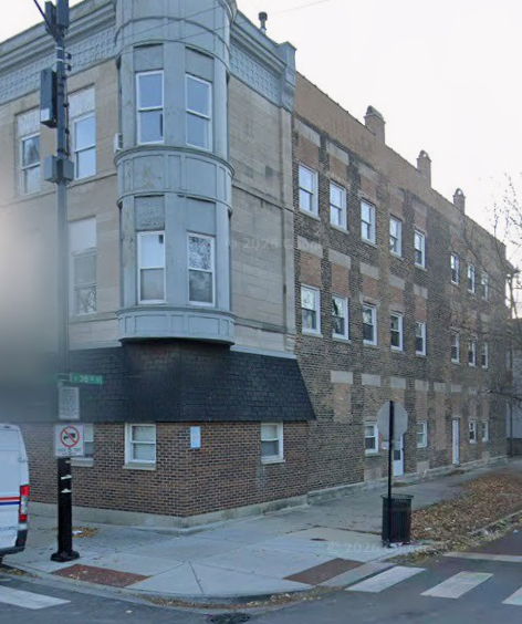 A street view of a building with a no parking sign.