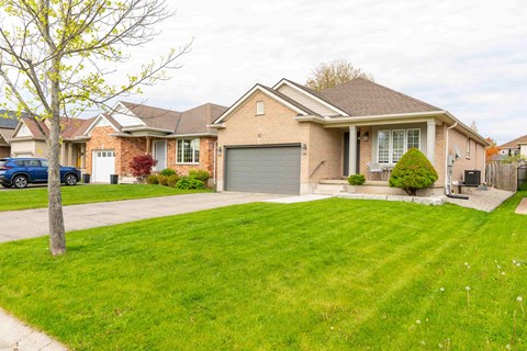 A house with a brown roof and a grey garage door.