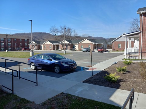 A blue car is parked in a parking lot.