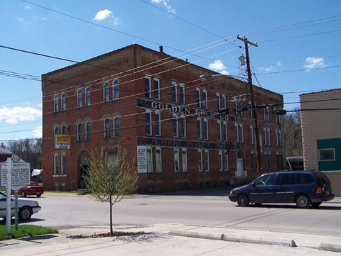 A large red brick building with a sign that says "Golden Eagle".