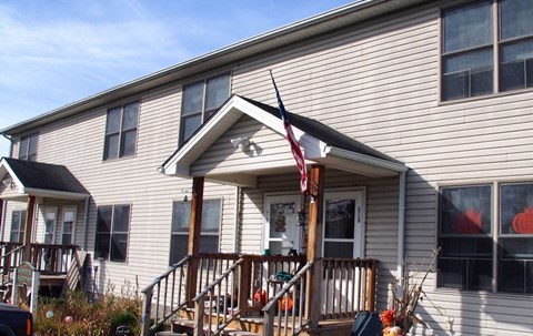 A house with a flag on the porch.
