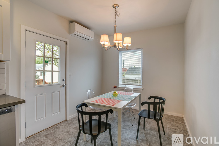 A dining room with a table and chairs.