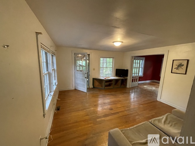 A living room with a couch and a television.