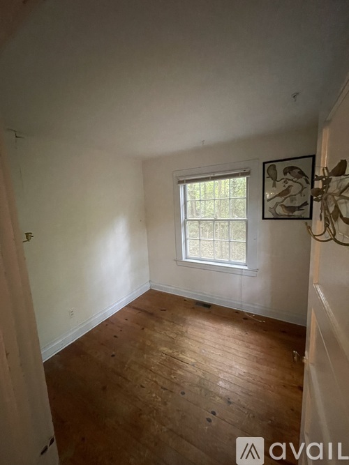 A room with wooden floors and a window.