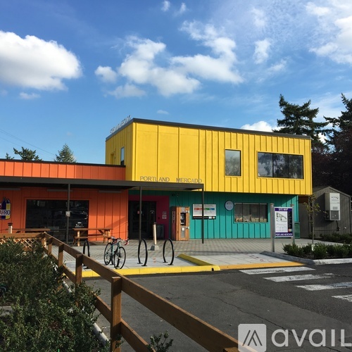 A brightly colored building with a bicycle parked in front.