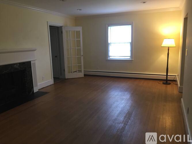 A room with a fireplace and a window.