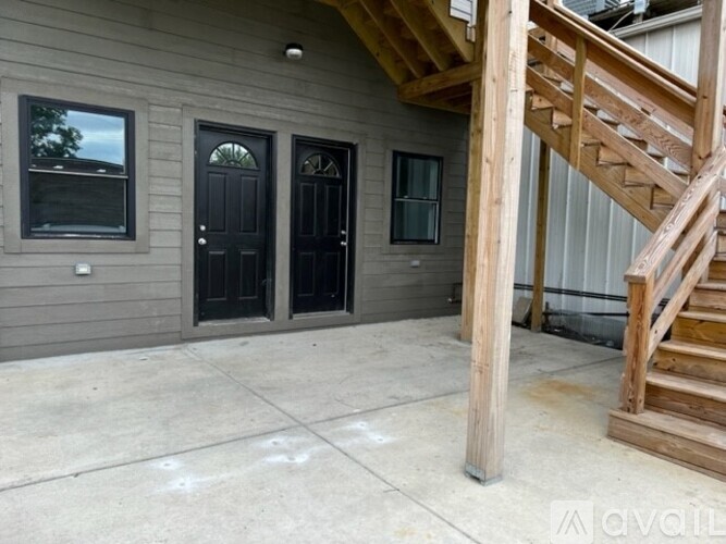 A house with a grey exterior and a wooden staircase.