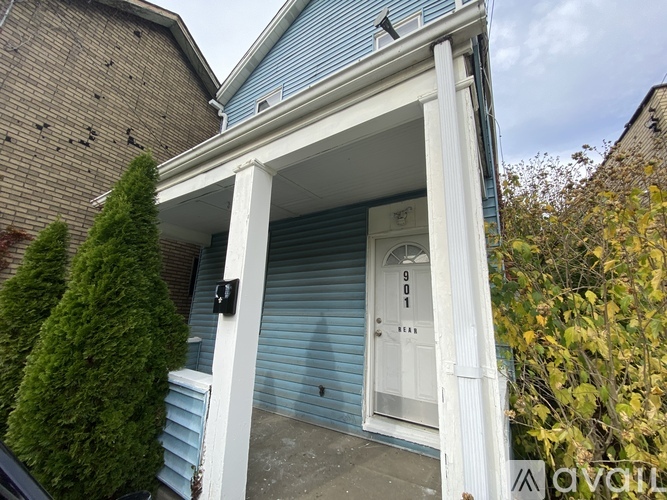 A blue house with a white door and a small porch.