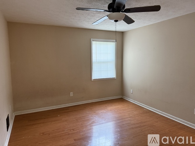 A room with a ceiling fan and a window.