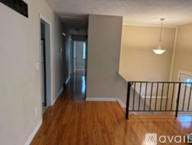 A room with wooden floors and a metal railing.