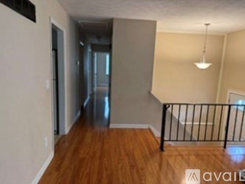 A room with wooden floors and a metal railing.