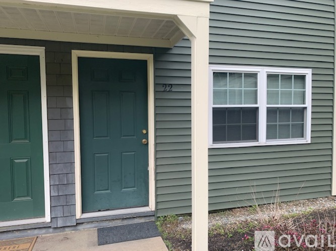 A house with a green door and a window.