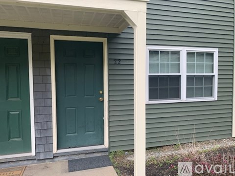 A house with a green door and a window.