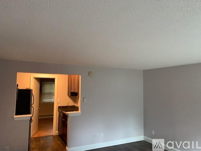 A kitchen area with a refrigerator and a countertop.
