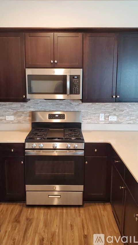 A kitchen with a stove and oven in the middle of the room.