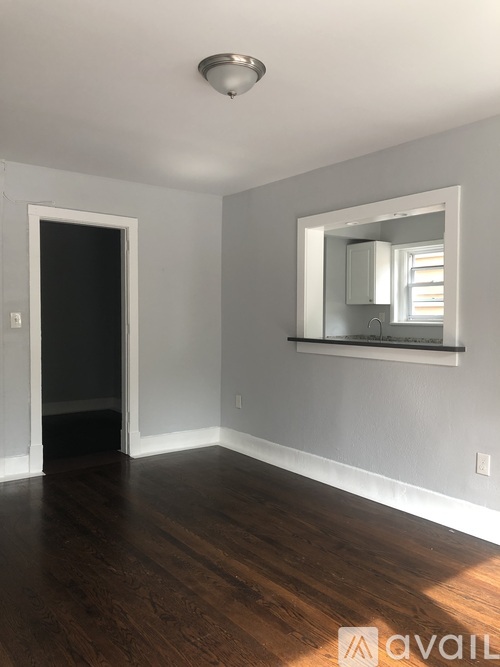 A room with a mirror and a door.