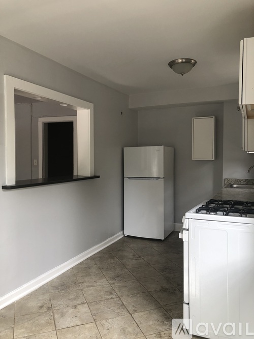 A kitchen with a white refrigerator and a white stove top oven.