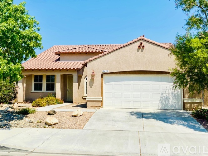 A house with a red tile roof and a white garage door.