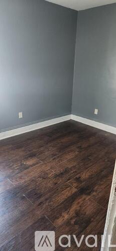 A room with grey walls and wooden flooring.