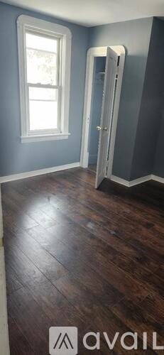 A room with a wooden floor and a white door.