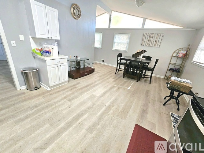 A kitchen with a dining table and chairs.