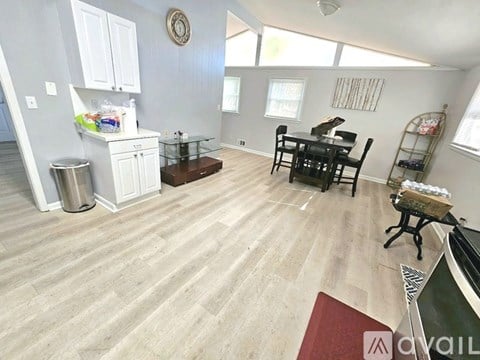 A kitchen with a dining table and chairs.