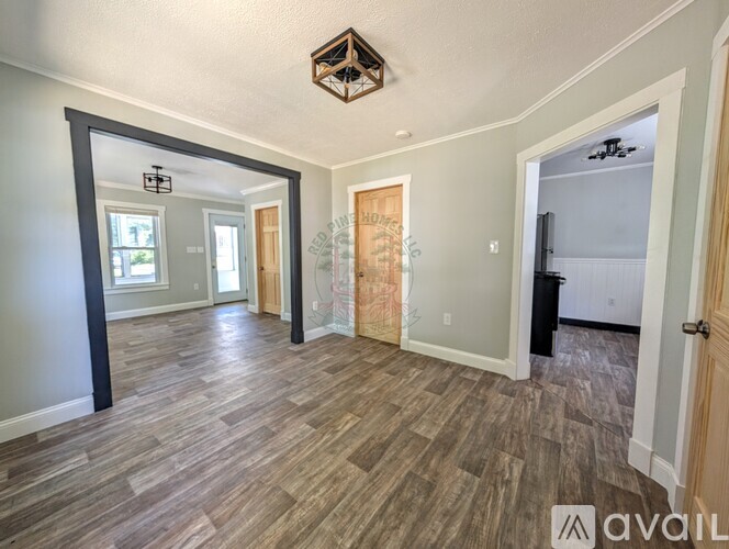 A room with wooden flooring and a hexagonal ceiling light.