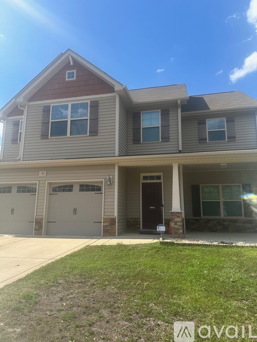 A two-story house with a garage on the first floor.