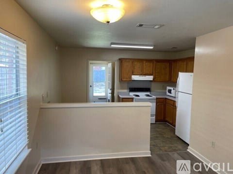 A kitchen with wooden cabinets and a white refrigerator.