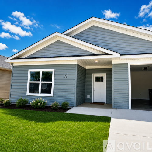 A house with a grey exterior and a white door is for sale.