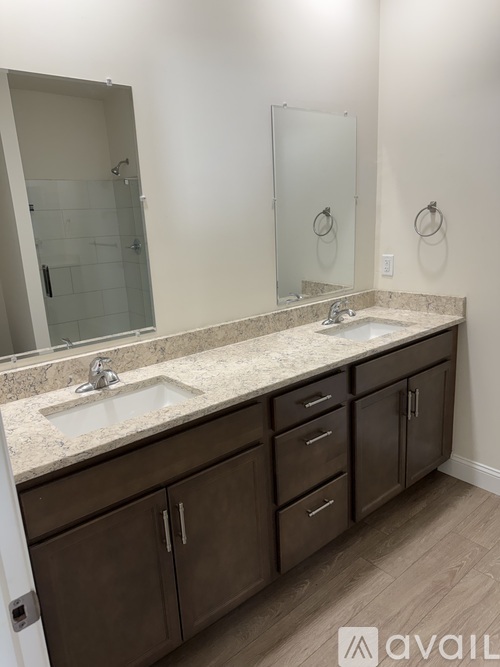 A bathroom with a marble countertop and a sink with a faucet.