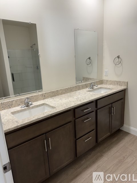 A bathroom with a marble countertop and a sink with a faucet.