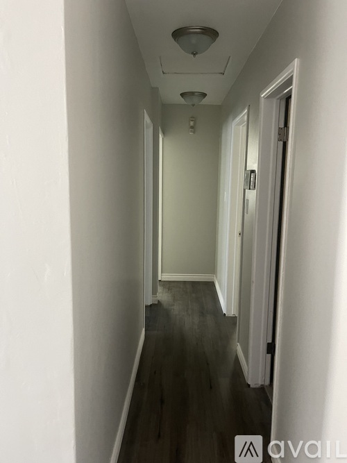 A long hallway with a door on the right.