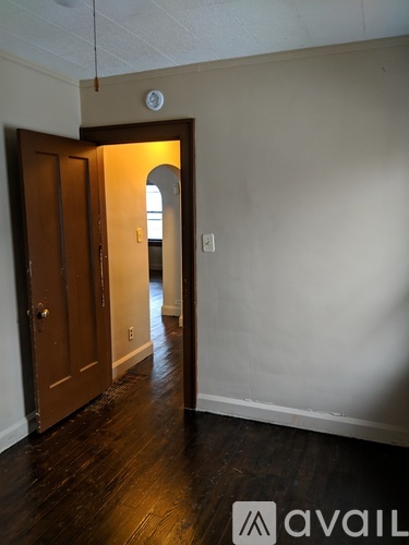 A room with a wooden door and a window.