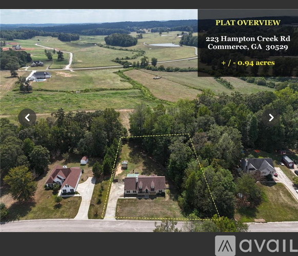 An aerial view of a property with a plat overview and a yellow dashed line indicating the property boundary.