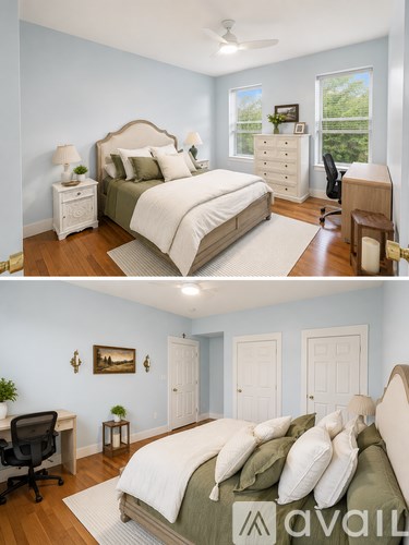 A bedroom with a large bed and a desk with a chair.