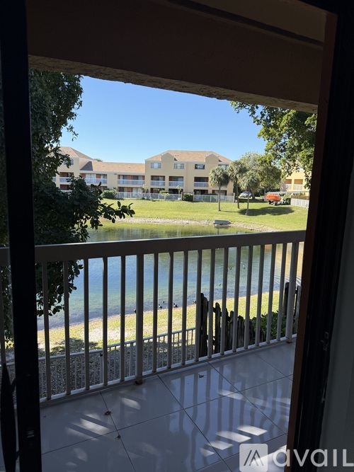 A view from a balcony looking out at a beach and buildings.