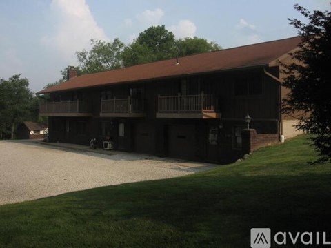 A large building with a balcony and a brown roof.