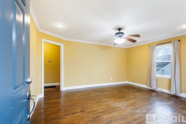 A room with a blue door and a yellow wall.