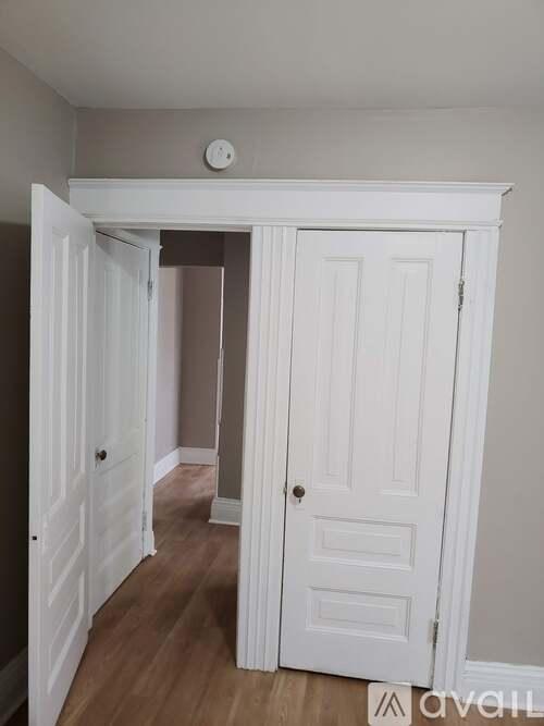 A white door is open to a hallway.