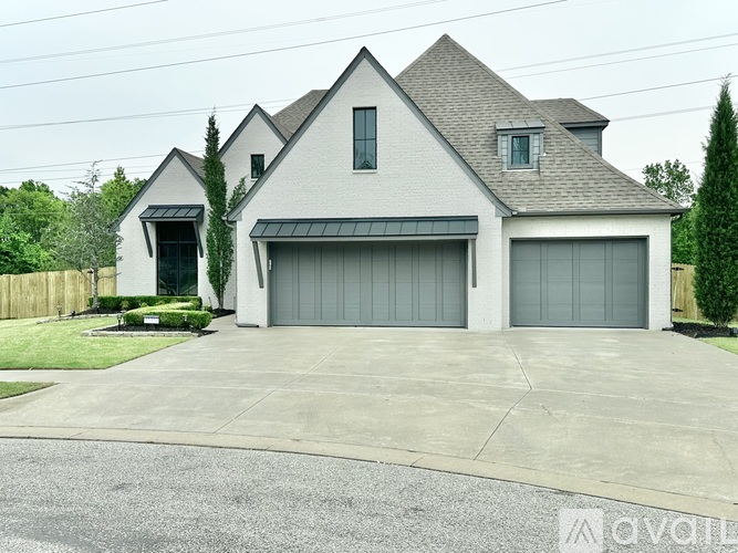 A two-story house with a garage on the side.