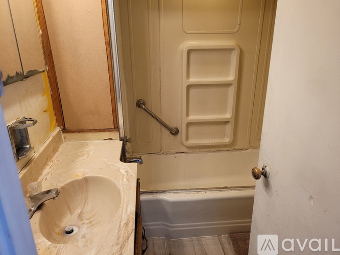 A bathroom with a sink, toilet and bathtub.