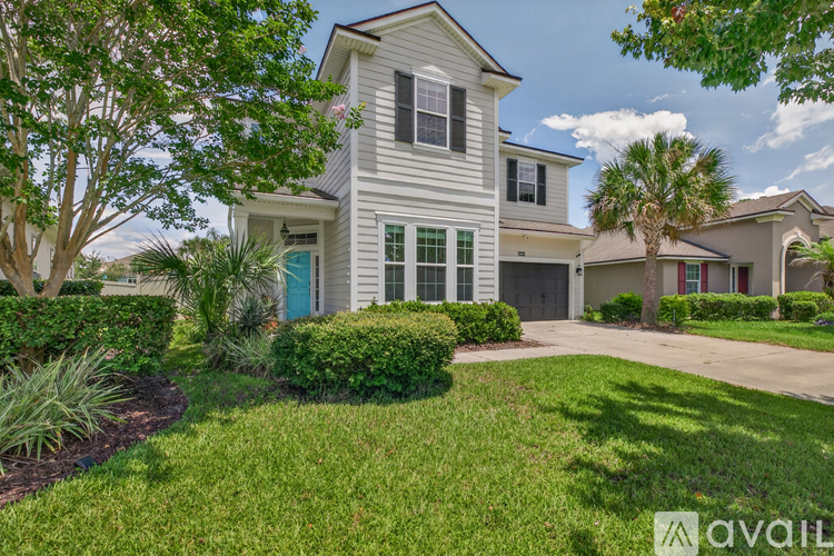 A house with a blue door and a white fence.