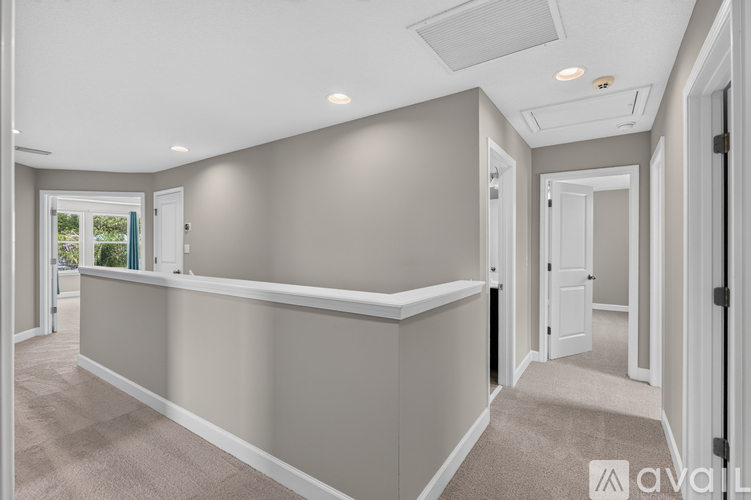 A spacious room with a skylight and a carpeted floor.