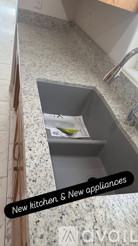 A kitchen counter with a sink and a drawer.