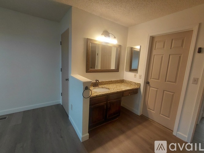 A bathroom with a sink, mirror, and medicine cabinet.