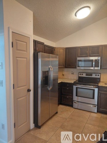 A kitchen with a stainless steel refrigerator and oven.