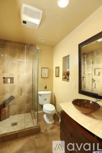 A bathroom with a toilet, sink, and shower.