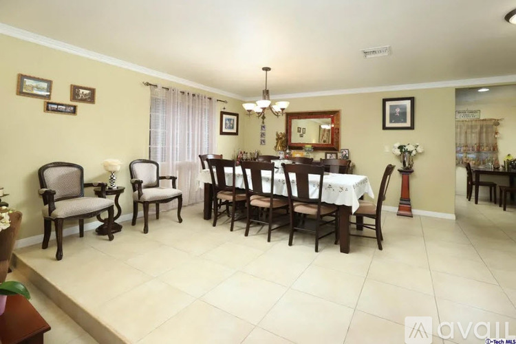 A dining room with a table set for six people.